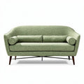 Green upholstered two-seater sofa with wooden legs and decorative cushions